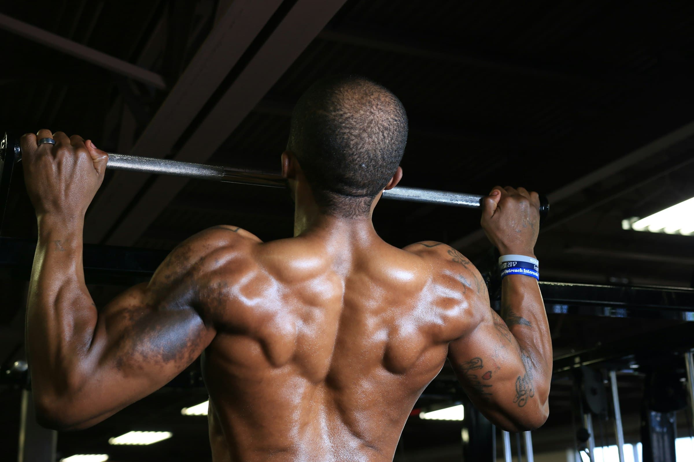 A man doing a pull-up, seen from behind